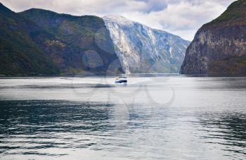 Landscape with Naeroyfjord, ship and mountains in Norway.