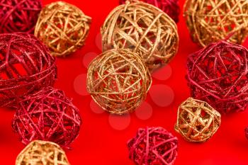 Christmas wooden colorful balls on red background.