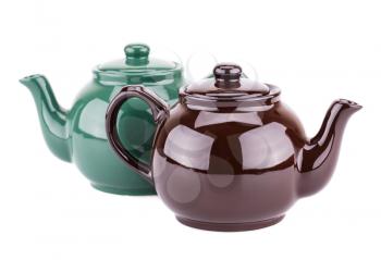 Green and brown teapots isolated on a white background.