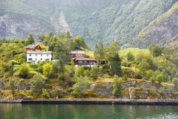 Landscape with Naeroyfjord, mountains and traditional houses in Norway.