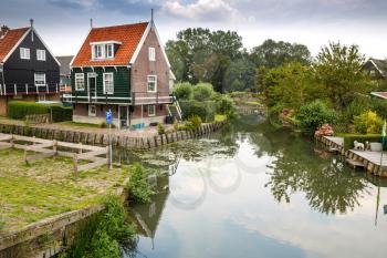 The old traditional colorful houses at the canal in the Dutch fisherman village Marken.