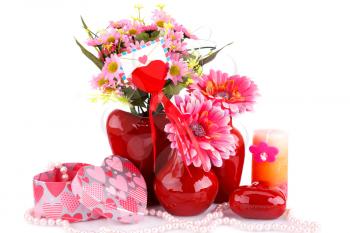 Flowers in vases, red heart glass, necklace, gift boxes and candle isolated on white background.