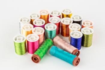 Colorful silk and cotton thread reels close up picture.