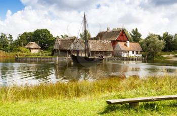 The medieval houses and boat in The Middle Ages Center, the experimental living history museum in Sundby Lolland, Denmark.