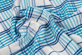 Blue and white kitchen towel texture as a background, horizontal picture.