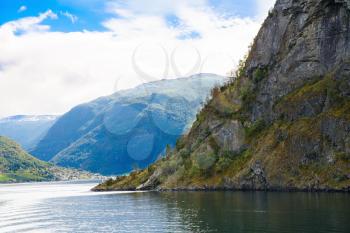 Landscape with Naeroyfjord, mountains and traditional village in Norway.