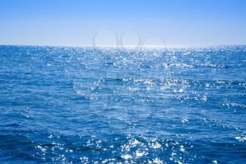 Blue Mediterranean sea with the sparkling surface.