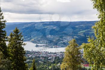 Landscape with mountains, river and buildings in Lillehammer town, Norway.