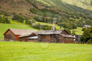 Old wooden houses and church in the rural place in Norway.