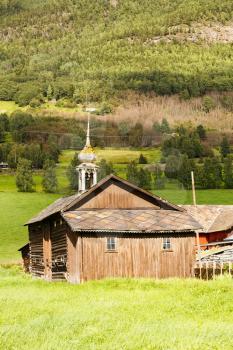 Old wooden houses and church in the rural place in Norway.