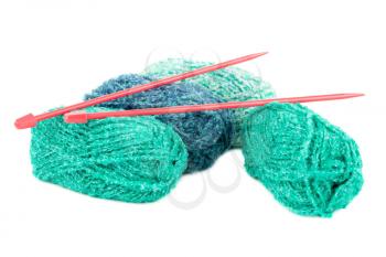 Four knitting yarn clews and needles isolated on white background.