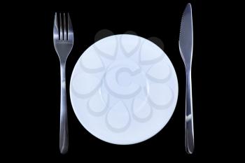Table serving-knife,plate,fork on  various colour background.
