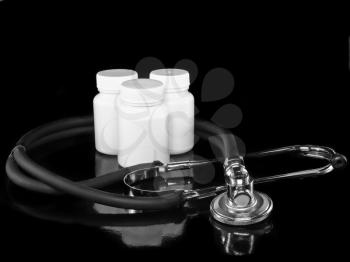 Stethoscope with medicine blank bottles on black background.