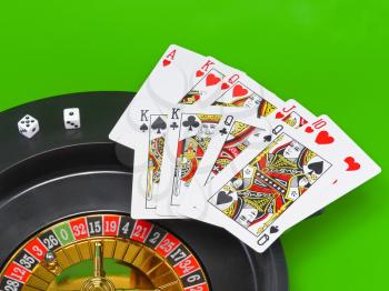 Casino- playing cards on green broadcloth (background).