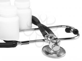 Stethoscope with medicine blank bottles on white background . Close-Up. Isolated.