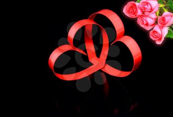 St. Valentine Day. Intertwining of two hearts, on black background with red roses.