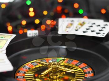 Casino roulette, dice and playing cards. On back background -casino lights.