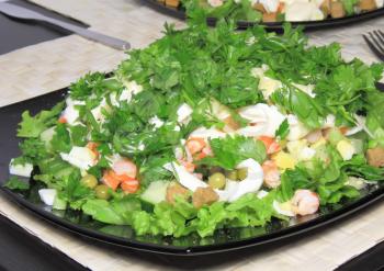 Salad with shrimps, dried crust, green peas and leaf of lettuce. Isolated