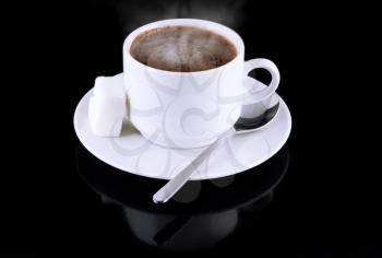 Cup of hot chocolate, sugar, on a black background.