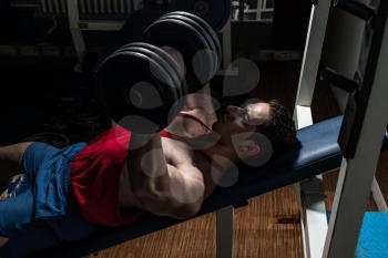 young bodybuilder doing bench press for chest