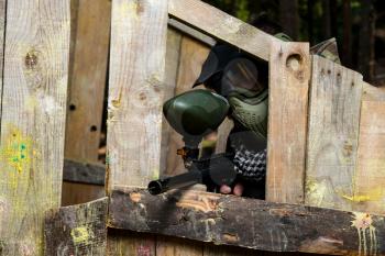 Players in paintball prepare for fight