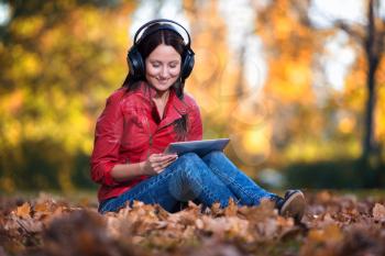 Girl Listening Music In The Autumn Sunshine