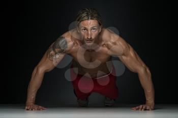 Middle Age Athlete Doing Pushups As Part Of Bodybuilding Training In A Studio