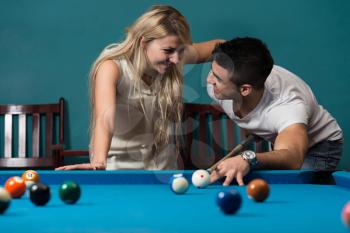 Boy And Girl Flirting On A Pool Game