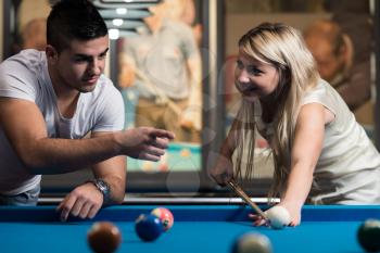 Man Showing His Girlfriend Where To Hit The Ball