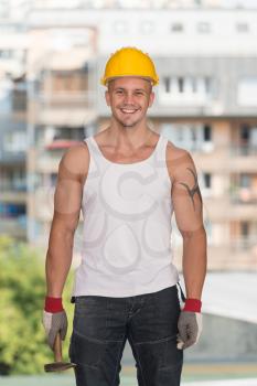 Handsome Construction Man Using A Hammer
