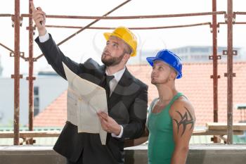 Group Of Male Architect And Construction Worker On Construction Site