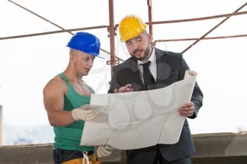 Group Of Male Architect And Construction Worker On Construction Site