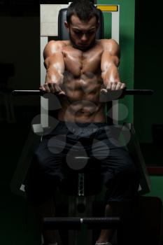 Young Man Doing Heavy Weight Exercise For Chest