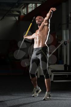 Mature Man Athlete Practicing To Throw A Javelin