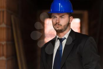 Portrait Of Business Man With Blue Helmet On Construction