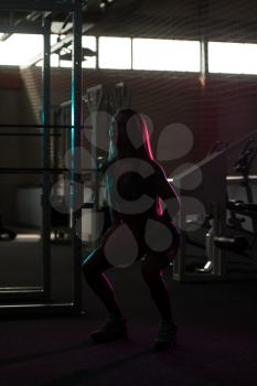 Silhouette Woman Standing Strong In The Gym And Flexing Muscles