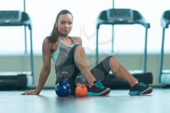 Portrait Of A Young Physically Fit Woman Relaxing In A Gym - Muscular Athletic Bodybuilder Fitness Model Resting