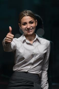 Happy Smiling Cheerful Business Woman In Office Showing Thumbs Up Gesture