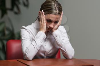 Stressed Woman Holding Her Head With Hand In Office - Business Woman With Problems - Businesswoman Working Online