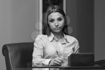 Portrait Of Attractive Businesswoman Reading Paper In Office - Notes Or Correspondence Or Signing A Document Or Agreement