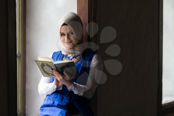 Humble Muslim Woman Is Reading The Koran In The Mosque