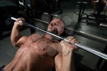 Muscular Man Doing Bench Press Exercise For Chest