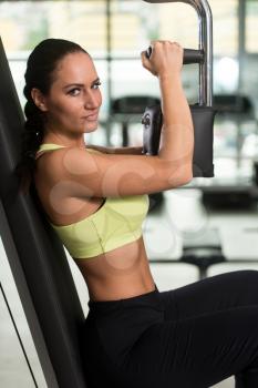 Attractive Woman Doing Heavy Weight Exercise For Chest On Butterfly Machine