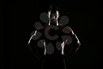 Silhouette Portrait Of A Young Physically Fit Man Showing His Well Trained Body - Muscular Athletic Bodybuilder Fitness Model Posing After Exercises