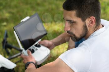 Young Engineer With Remote Control Preparing to Flying a Drone in Park