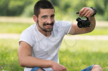 Closeup of Young Engineer Man Checking the Camera from a Drone With Hand in Park