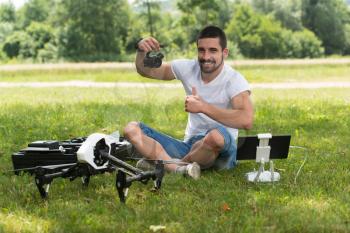 Closeup of Young Engineer Man Checking the Camera from a Drone With Hand in Park