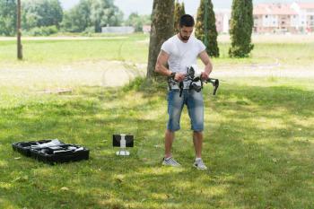 Young Engineer Man Prepares a Drone to Flight in Park
