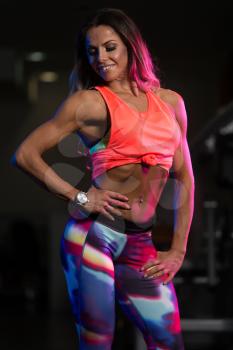 Portrait Of A Physically Fit Woman Showing Her Well Trained Body - Muscular Athletic Bodybuilder Fitness Model Posing After Exercises