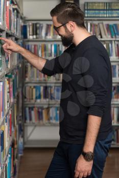 Portrait Of An Caucasian College Student Man In Library - Shallow Depth Of Field